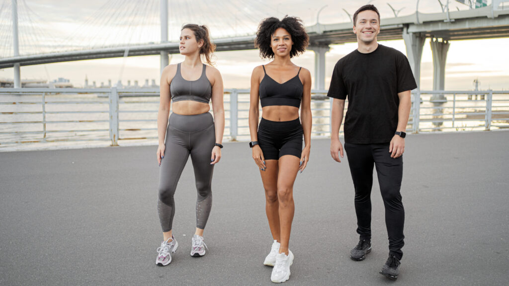 three friends enjoying run city bridge representing friendship fitness